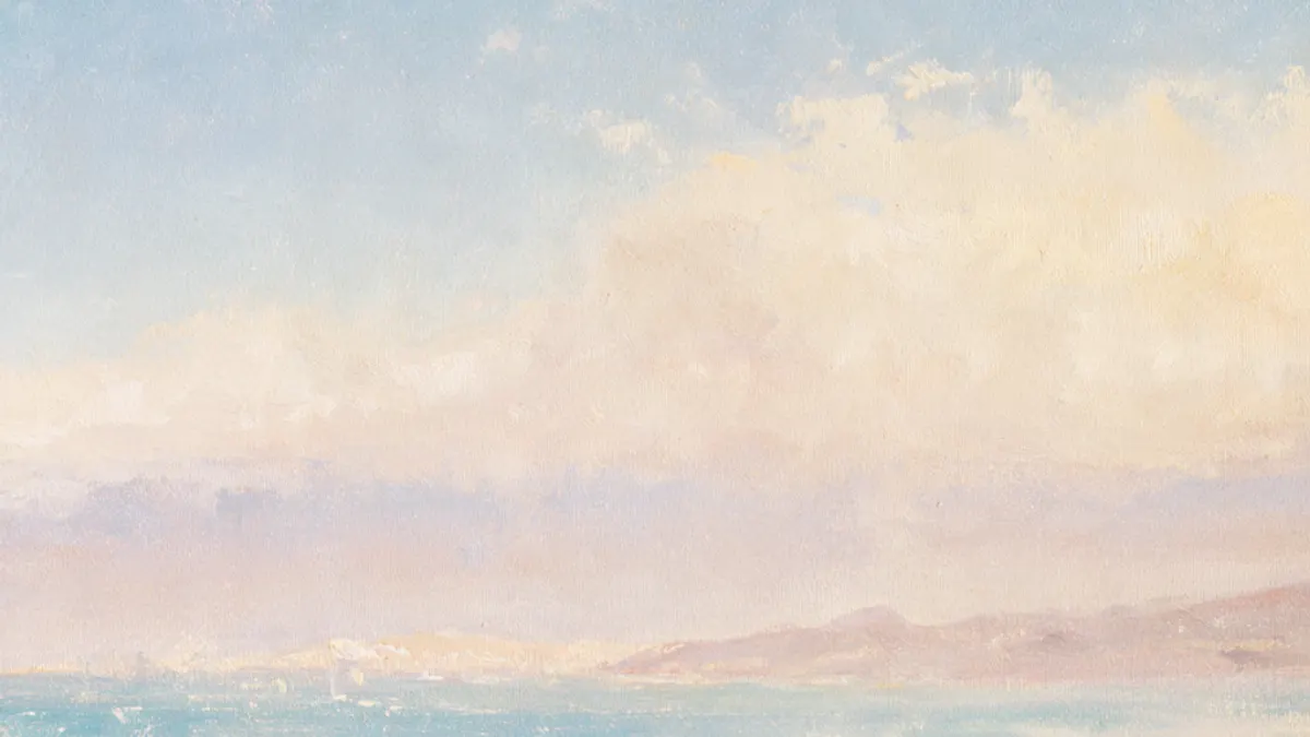 An empty shore under a pale sky, the sea running out to a bare horizon